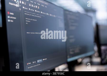 Close up of computers in data center running server rigs diagnostic tests and error checking utilities to identify and resolve software problems. PC software used to monitor critical systems Stock Photo