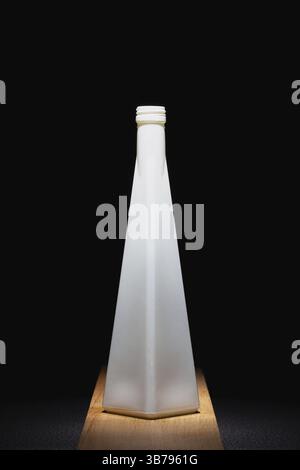 White empty vase on the wooden table in the dark room. Home decoration Stock Photo