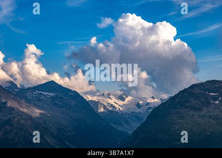 Beautiful Aerial View over Swiss Alps with Glacier in a Sunny Day and Clouds over St Moritz, Maloja, Grisons, Switzerland. Stock Photo