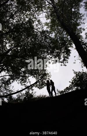 Silhouette of two girls, an afternoon at the park, Great Falls, Montana. Stock Photo