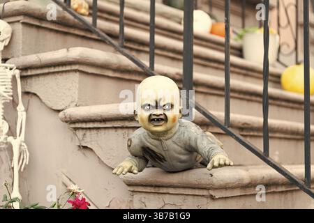 Spooky zombie baby. Halloween outdoor zombie baby decoration. Happy Halloween zombie baby. Trick or treat. Celebrate All Hallows holiday. All Hallows Stock Photo
