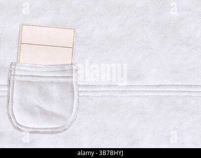 Horizontal backdrop with paper tag in suede pocket. Eco-friendly paper label in suede leather pocket of ivory color. Sustainable development of strate Stock Photo