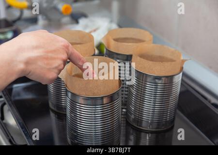 Steel molds on a roasting pan prepared for baking Easter bread. Stock Photo