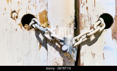 Old gates with padlock and chain Stock Photo