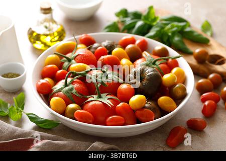 Fresh ripe cherry tomatoes and large red tomatoes Stock Photo