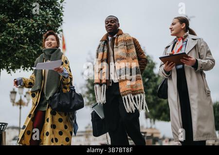Diverse people walking outdoors engaging in teamwork and discussions Stock Photo