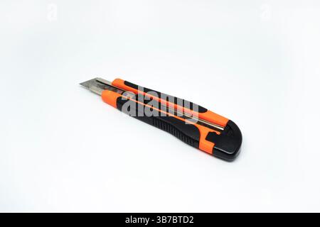 Closeup view of orange cardboard cutter isolated on white background. Box cutter isolated Stock Photo