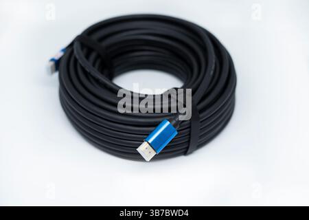 Video cable Display Port to HDMI, 20 meters, black, rolled into a ring, with two gold-plated connectors. Top View. Isolated on white Stock Photo