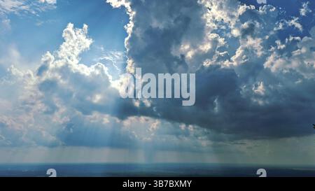 blue sky with bright light between the white clouds Stock Photo