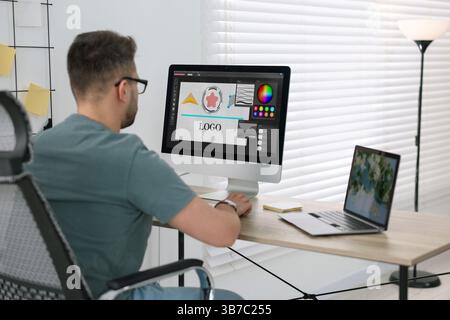 Designer working on different computers at table in office Stock Photo