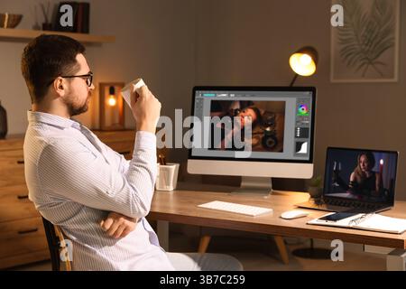 Designer working on different computers at table in office Stock Photo