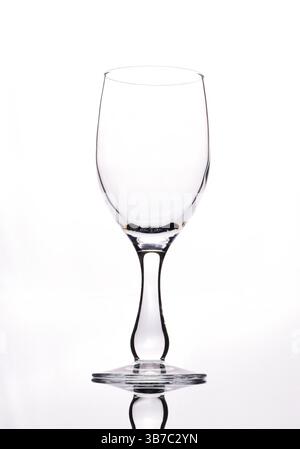 An empty wine glass outlined against a plain white background Stock Photo
