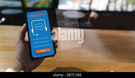 Businessman using AI chatbot interface on laptop for digital contact center support. Modern communication and customer service technology concept in a Stock Photo