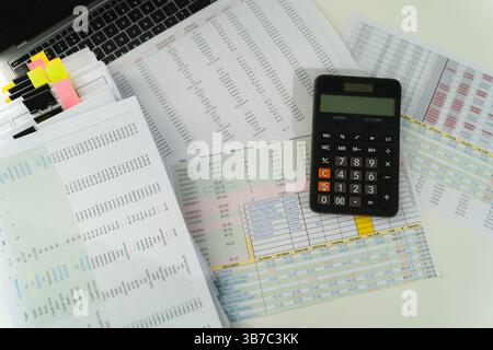 man accountant working on desk using calculator calculate while working analytic Accounting Stock Photo