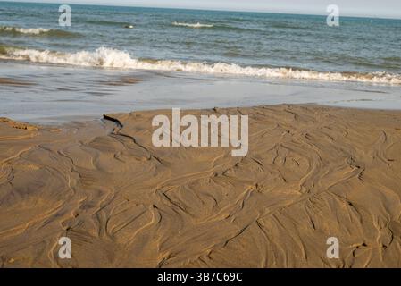 Patterns in sand at low tide on beach created by receding tide Stock Photo