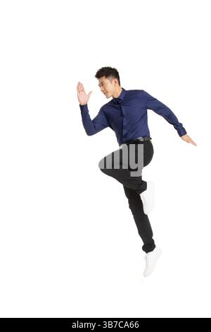 A businessman running with a smartphone in hand. Stock Photo