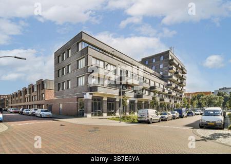 A building with multiple floors and balconies is set against a clear ...