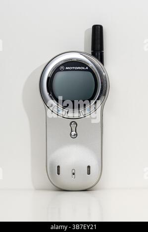 Motorola V70 vintage mobile phone with extended antenna standing on a white background Stock Photo