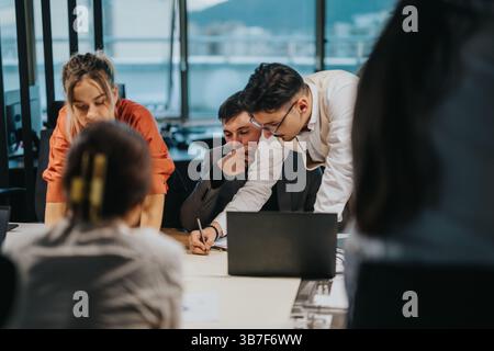 Multicultural team collaborating on project at modern office Stock Photo