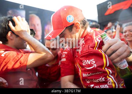 Charles Leclerc of Scuderia Ferrari celebrates victory with the trophy ...