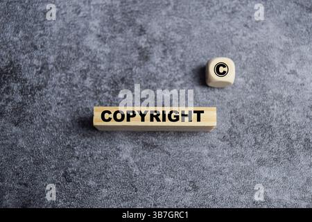 The word copyright and copyright symbol on wooden blocks on the table. concept of patenting or copyright protection Stock Photo