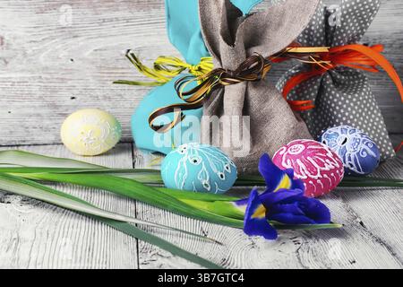 Painted Easter eggs, an iris flower and pouches with ears Stock Photo
