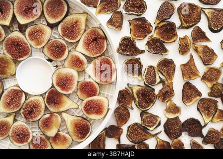 Sliced fresh and dried figs lie on the table. Top view. Stock Photo