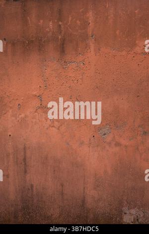 red concrete wall in distress and cracked Stock Photo