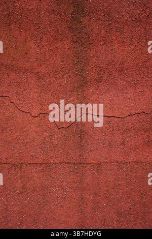 red concrete wall in distress and cracked Stock Photo
