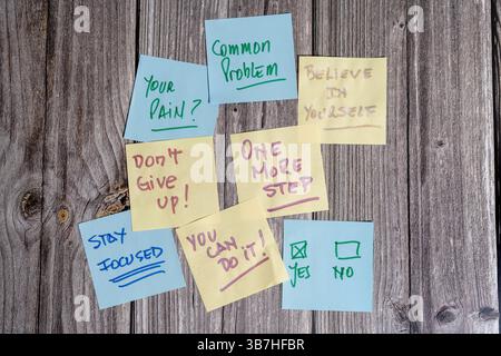Colorful sticky notes with uplifting messages offer encouragement and promote a positive mindset Stock Photo