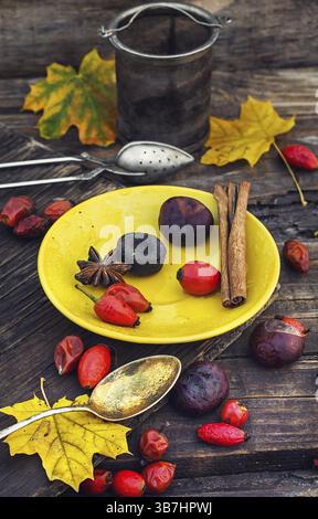 Still life with yellow cup of tea, sipontum, leaves and chestnuts Stock Photo