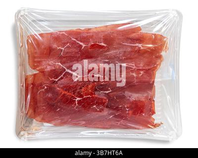 Carne Salada, traditional Italian cured raw beef from Trentino, vacuum packed in clear plastic tray isolated on white with clipping path included Stock Photo