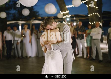 Groom hugs bride in dance in restaurant. Stock Photo
