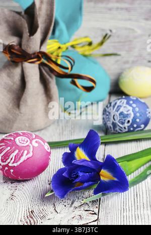 Painted Easter eggs, an iris flower and pouches with ears Stock Photo