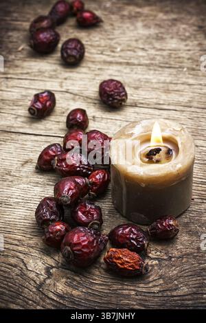 Dried berries of the wild rose on wooden table in rustic style Stock Photo