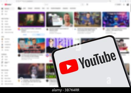 Stuttgart, Germany - February 8, 2025: YouTube app logo internet online video sharing platform on a mobile phone and computer in Stuttgart, Germany. Stock Photo