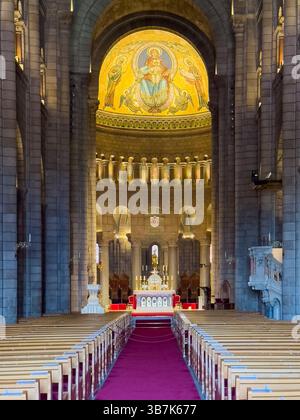 Principality of Monaco, France - July 9, 2024: Cathedral of Our Immaculate Lady. The chancel seen from halfway in with the altar and the golden ceilin Stock Photo