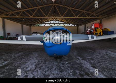 An airplane parked in a hanger. It's a aircraft on an airport Stock Photo