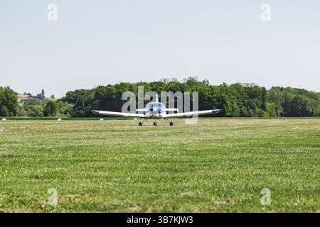 An airplane on a grass runway. The aircraft is ready to fly. It's a transportation for people Stock Photo