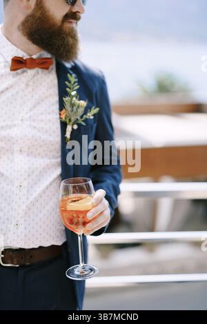 Bearded redhead groom with a glass in his hand. Stock Photo