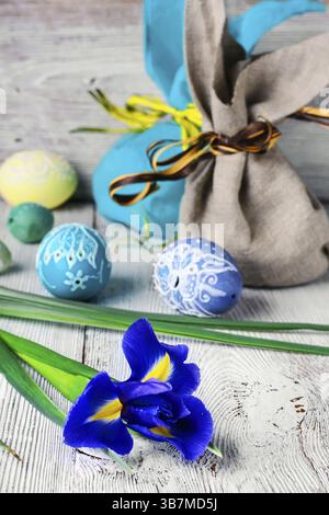 Painted Easter eggs, an iris flower and pouches with ears Stock Photo