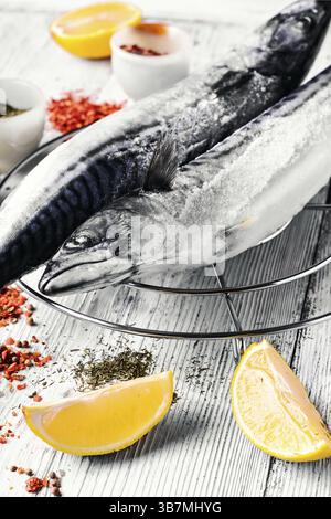 Thawed fresh fish mackerel with spices and marinade.Photograph high key Stock Photo