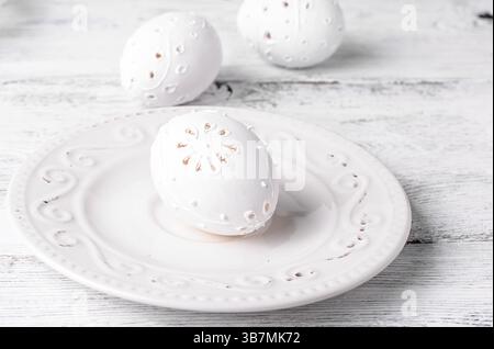 Easter eggs with cut out pattern by hand on light background.the photograph high key Stock Photo