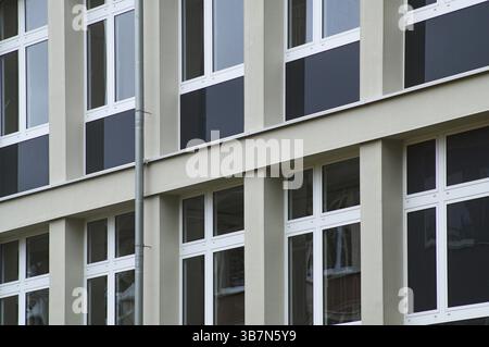 Modern architecture featuring a geometric pattern of windows and concrete panels on a building facade Stock Photo
