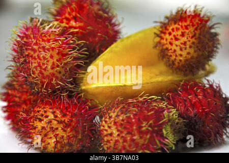 Tropical fruits. still life with rambutans and carambola Stock Photo