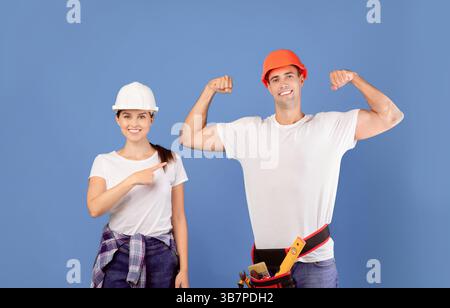 DIY Renovation. Woman Pointing At Strong Boyfriend While They Doing Repair Together Stock Photo