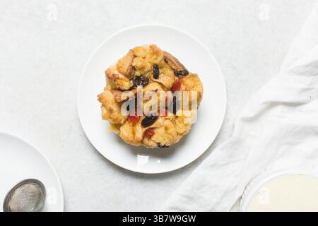 Overhead view of homemade bread pudding with raisins, top view of fresh bread pudding with raisins on a white background Stock Photo