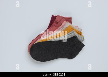 Set of colored socks on a white background. Top view Stock Photo