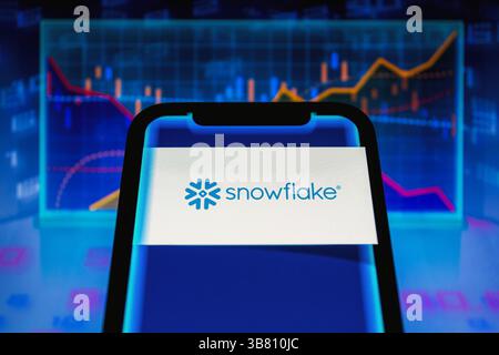 February 29, 2024, Asuncion, Paraguay: Logo of Snowflake (NYSE: SNOW), the data cloud company, is displayed on a smartphone backdropped by visual representation of stock and line charts. (Credit Image: © Andre M. Chang/ZUMA Press Wire) Stock Photo
