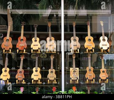 Ukulele's Hawaiian guitars in a shop window. Honolulu, Hawaii. Display of guitars in a window Stock Photo